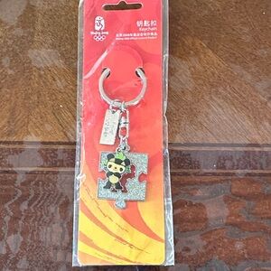 Silver Olympic Keychain with Puzzle Piece